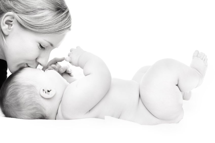 8860685 - happy mother kissing baby girl against white background